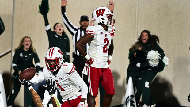 Wisconsin cornerbacks Ricardo Hallman and Jay Shaw looking on as MSU Keon Coleman celebrates a touchdown.